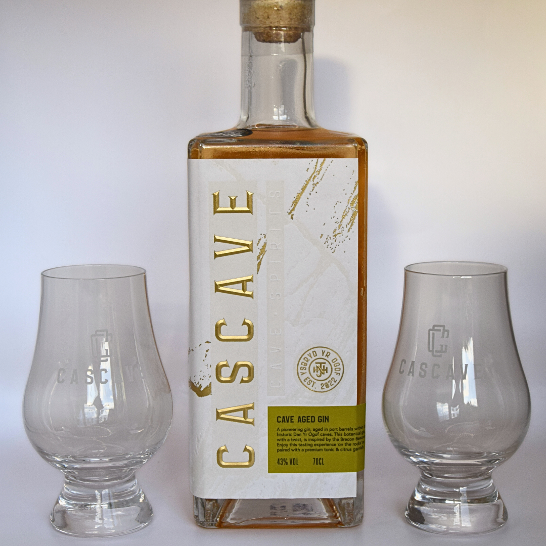 Bottle of Casave gin with two glasses on a white background